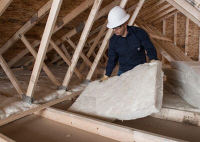 Austin Company | installing fiberglass in attic of residential home