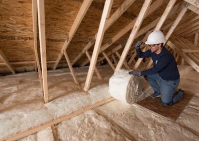 Austin Company | installing fiberglass in attic of home