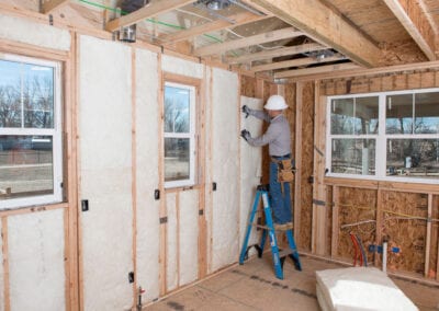 Austin Company | installing fiberglass in walls of home