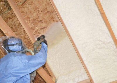 Austin Company | worker in protective gear installing spray foam insulation