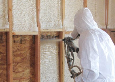 Austin Company | worker in protective gear installing spray foam insulation