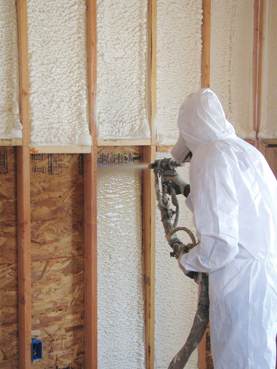 Austin Company | worker in protective gear installing spray foam insulation